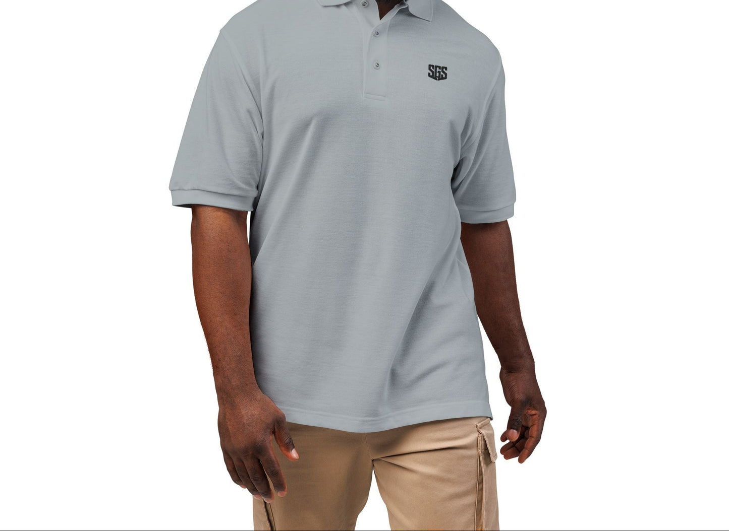 Man wearing a gray polo shirt with a logo on a white background