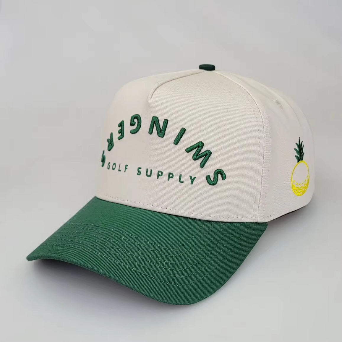 Cream and green 5-panel golf snapback hat with SWINGERS Golf Supply logo